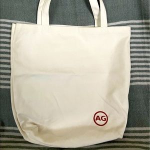 AG Adriano Gildschmied white canvas tote.